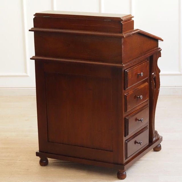A solid wood Davenport secretary desk in the style of 19th-century Victorian Davenport desks likely from the second half...