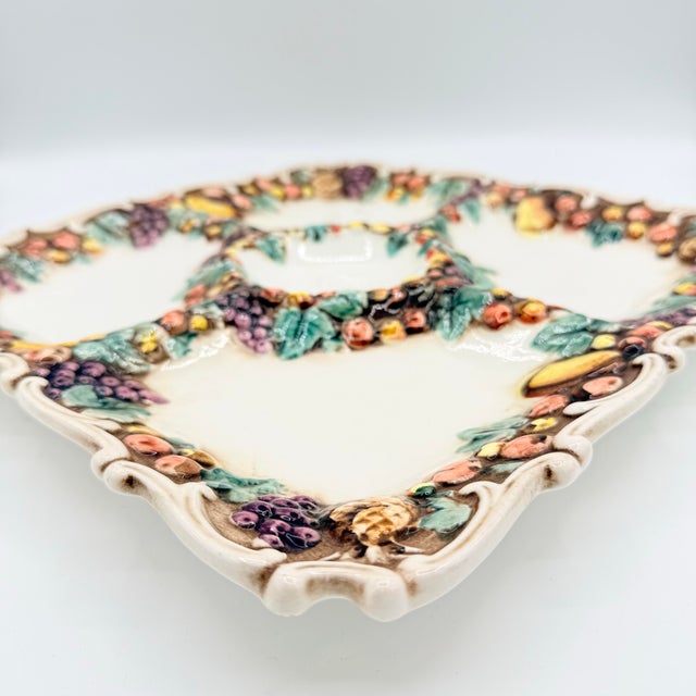 A wonderfully exuberant vintage serving platter in the Della Robbia tradition, richly decorated with dimensional fruit and...