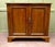 This is a neat panelled door oak cupboard, it stands on a bracket footed plinth and has along shelf to the inside, above...