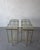 This is a stunning pair of custom brass and cast glass console tables. The thin, architectural lines of the tube brass...