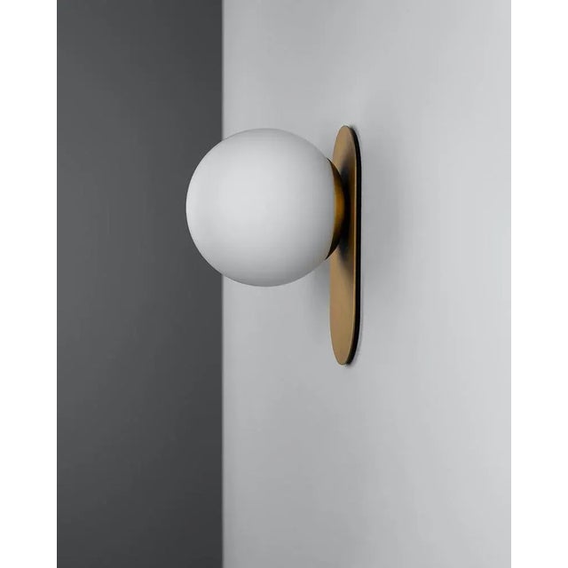 Gold adrion wall sconce sm by schwung dimensions: w 15 x d 16.1 x h 23 cm materials: brass, frosted glass. All our lamps...