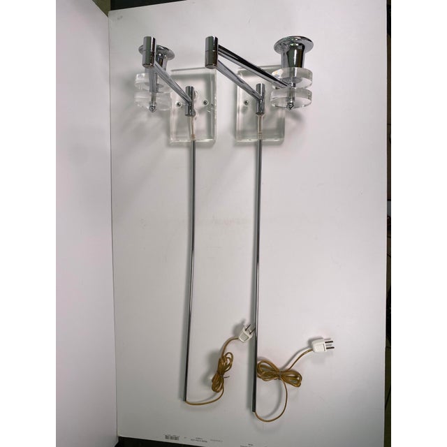 An elegant pair of oversized Modern wall sconces crafted in polished chrome with substantial clear lucite accents. Each...