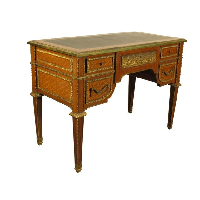 An early 20th-C. French Louis XVI style tulipwood writing table with satinwood and kingwood inlays, extensive gold plated...