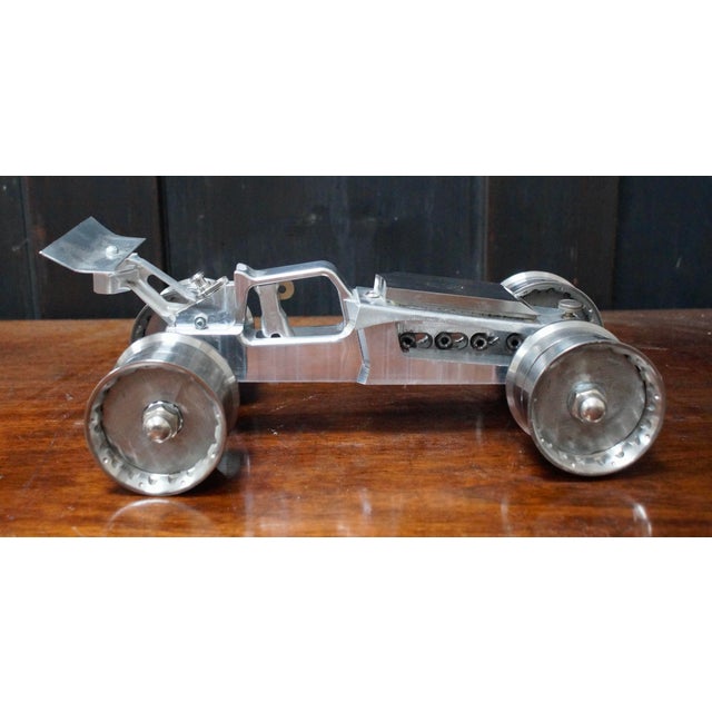 A Custom Steampunk Racing Car. This sculpture is in the form of a Racing car, completely made from McLaren car parts and...