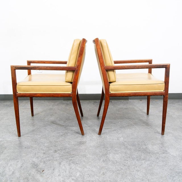 Pair of solid walnut arm chairs and tan vinyl upholstery (unmarked). Nice squared frames and sculptural elements...
