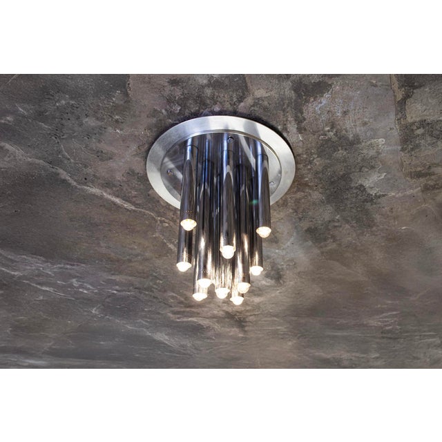Thirteen-light chandelier in chromed metal. Manufacturer: Reggiani 1970s I have official proof of authenticity such as...
