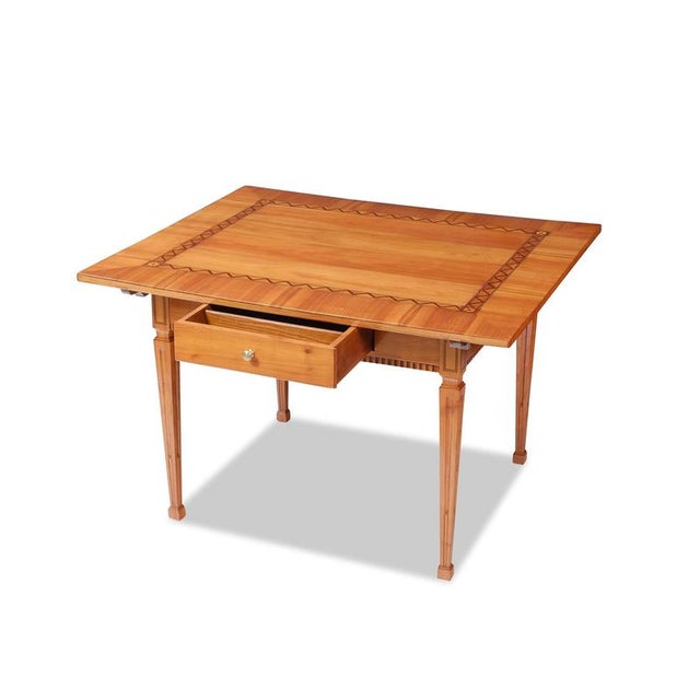 Louis XVI dining table, Southern Germany, circa 1790, cherry wood with fine inlay work in plum, maple, and ebony; in...