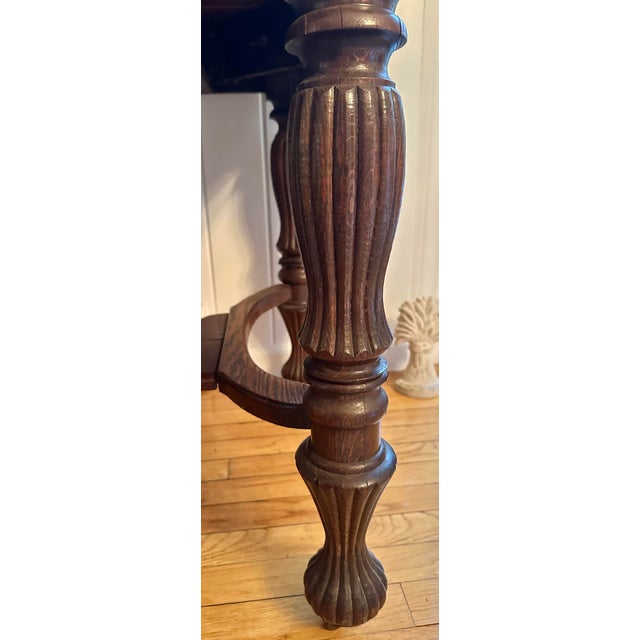 Antique quarter-sawn oak Jacobean Revival library table with turned legs, original casters, dovetail drawer construction,...
