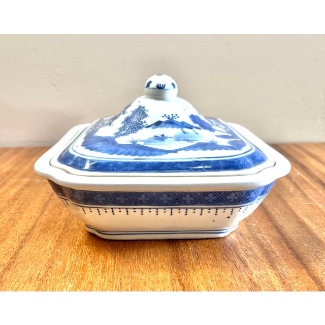 Chinoiserie blue and white porcelain tureen, possibly 19th-century, featuring the classic "Canton pattern," depicting a...