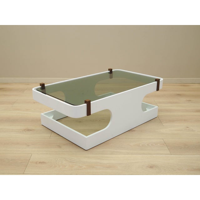 The coffee table was made in the 1970s, Italian production. The structure is made of plywood stained white. The tabletop...