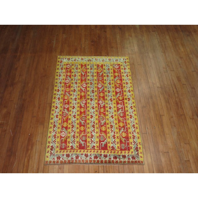 Fascinating early 20th century Turkish Melas carpet in bright yellow and bright red. The vertical design was cleverly...