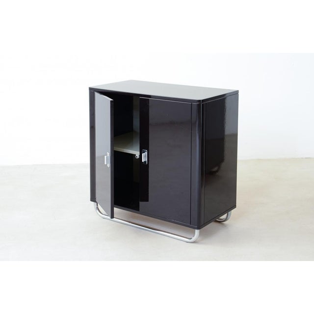 Pair of small storage units in lacquered wood with chromed tubular base and interiors in ivory lacquered wood. BAUHAUS STYLE