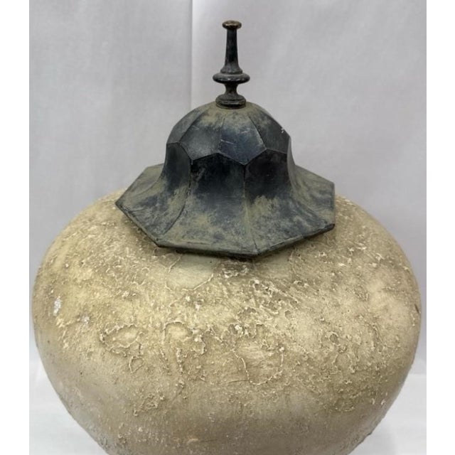 A striking decorative covered jar in the Chinoiserie taste, featuring a generously proportioned globular ceramic body with...