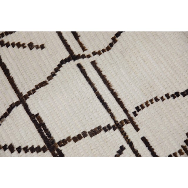Introducing our exquisite handwoven wool modern Moroccan-style rug, a stunning blend of traditional craftsmanship and...