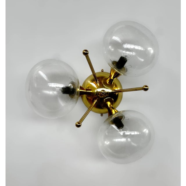 Italian flush mount with 3 clear pebble shaped Murano glass shades mounted on solid brass frame in lacquered polished...