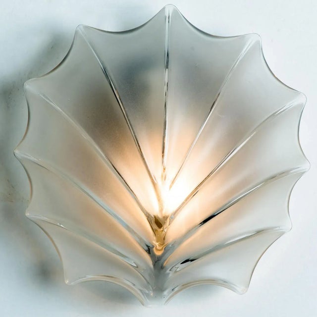 Pair of leaf shaped wall lights in textured glass with silver details. Manufactured by in germany the during the 1970s....