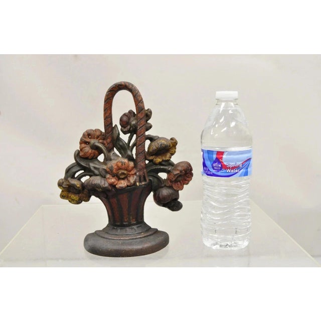 Antique Victorian Red Cast Iron Figural Painted Floral Bouquet Basket Door Stop. Circa Early 20th Century. Measurements:...