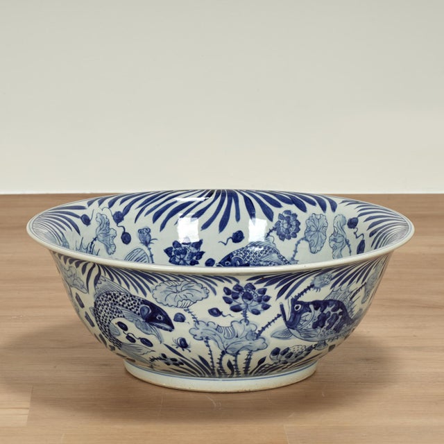 Enchanting large Chinese blue and white porcelain bowl, with classic form, having a hand decorated aquatic scene with fish...