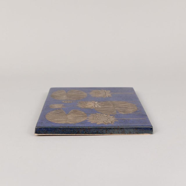 A Swedish ceramic wall plaque by Heinz Erret for Gustavsberg, circa 1970s, featuring the White Water Lily motif with...