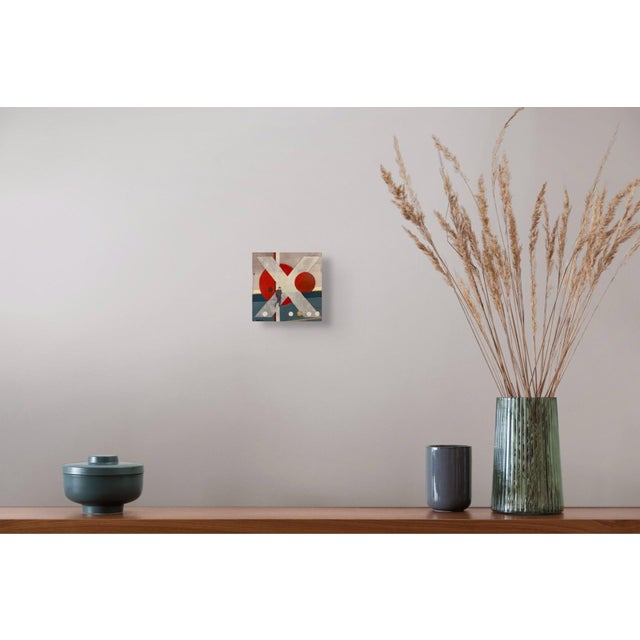 This mixed media work features a dynamic interplay of geometric shapes, with bold red and white forms creating a striking...