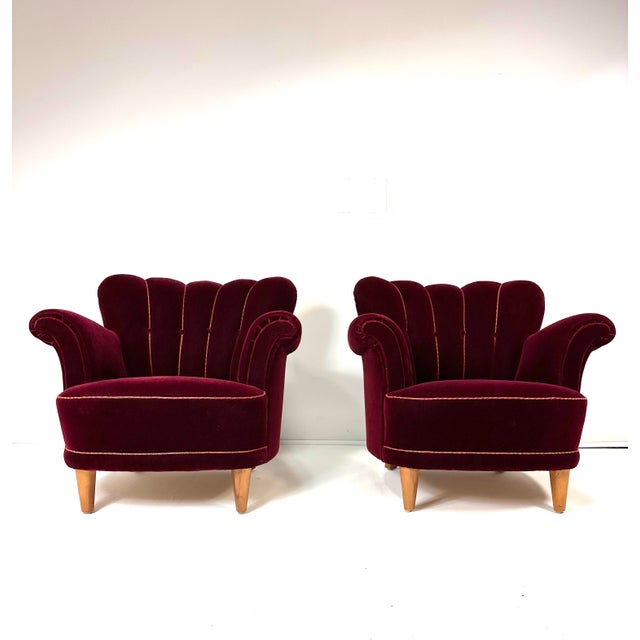 Pair of 1940's Swedish Lounge Chairs. Deep red channel back velvet upholstery. in original condition. Beech wood legs.