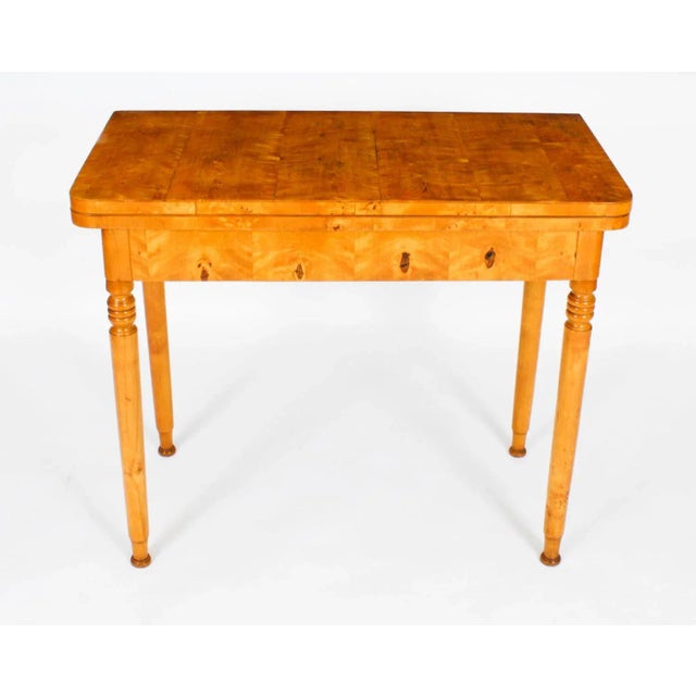 This is a stylish antique Swedish Biedermeier Period birch console/card table and overmantle mirror, circa 1880 in date....