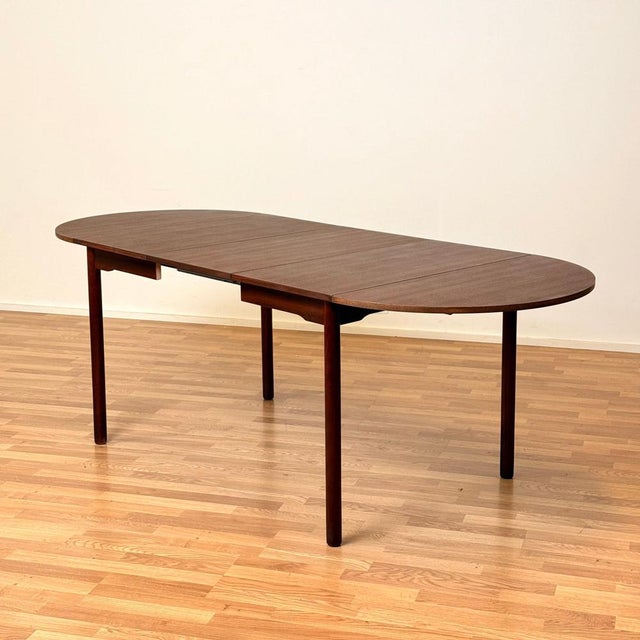 The dining table was made in Denmark in the 1950s-60s. Many call this the "Arne Vodder" style table. It is made of...