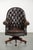 This beautiful old brown cowhide Chesterfield office chair on wheels is in a luxurious English style. It stands on wheels...