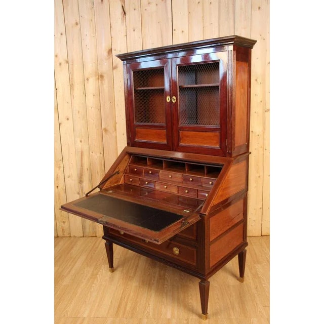 Pretty scriban Library has two solid mahogany and marked nets, opening by three drawers in the lower part and two mesh...