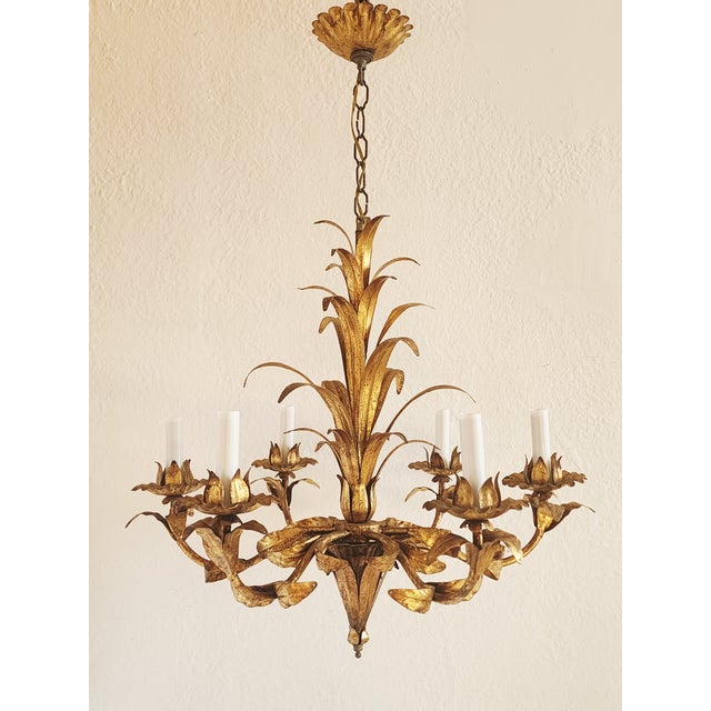 Gorgeous Italian gilt metal motif Hollywood Regency style chandelier with 6 lights. Featuring palm leaf motif on the...