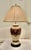 Bulbous folk art painted table lamp. This an attractive pottery lamp painted in a folk art style, in crackle finish Gold,...