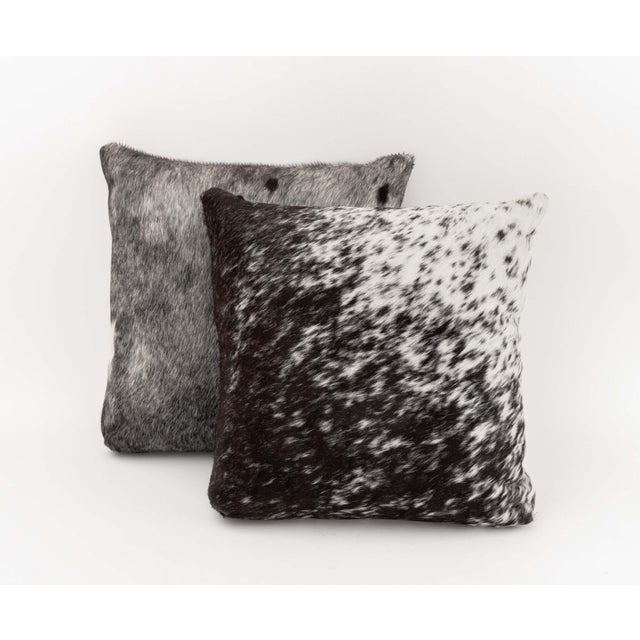 Pair of Modern Cowhide Throw Pillows, each with zipper closure. 18.5" L x 18.5" W x 6.5" D. Provenance: From a SoHo, New...