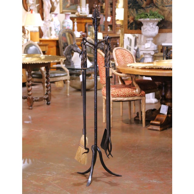 This vintage French Gothic fireplace tool set, known as a Serviteur, was crafted in wrought iron during the mid-20th...