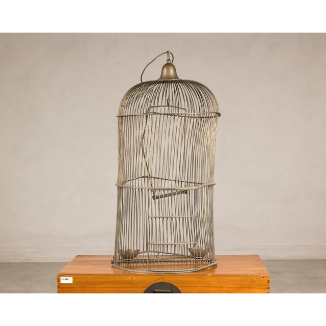 This antique Indian brass bird cage presents a wonderfully sculptural silhouette, with its tall proportions, domed top,...