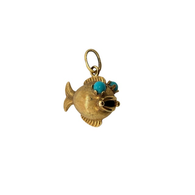 A playful 1960s fish pendant made in 18 karat yellow gold, with Persian turquoise cabochon eyes that add a bright pop of...