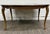 This is a vintage French Provincial–style dining table featuring a shaped walnut-veneer top, scalloped apron, slender...