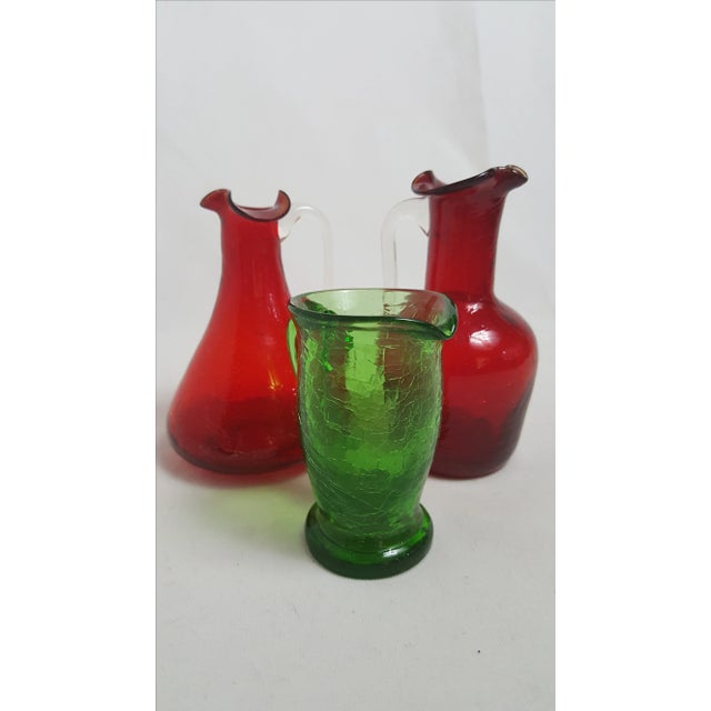 Two red Blenko and one green Pilgrim Pitcher. All three are in perfect condition.