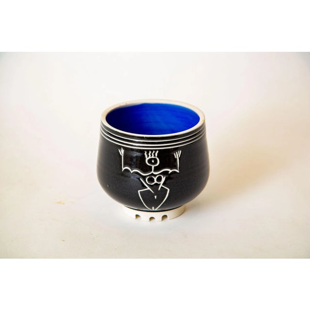 This interesting studio ceramic small bowl is signed Goldenberg. It has a great stick womens figure as the center. It is...