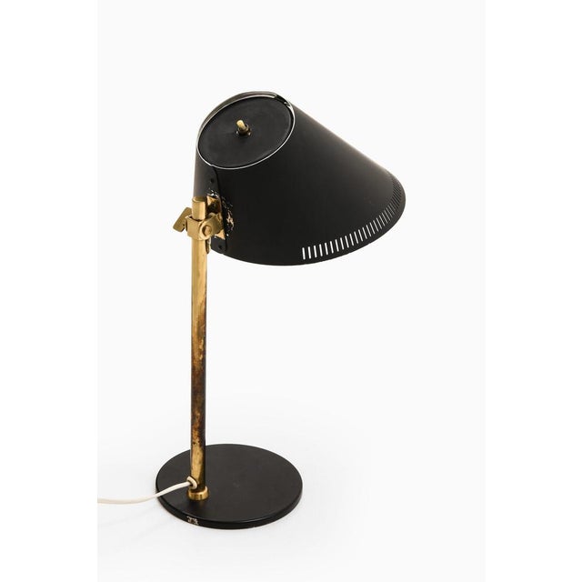 Table lamp in brass and black lacquered metal by paavo tynell, 1950's additional information: material: brass and black...