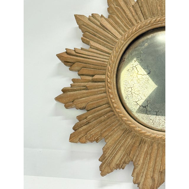 Mid-20th-century convex wall mirror with a dramatic composition sunburst frame, the circular center fitted with a domed...