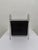 Mid-Century magazine rack with leather sling magazine holder attached to a bent steel frame.