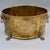A handsome vintage brass jardinière in the English Regency style, featuring lion-head ring handles on either side and paw-...