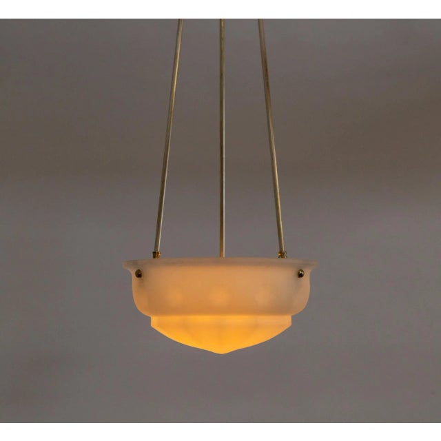 A three-stem pendant light with a frosted glass shade from the early 1900s. The glass is a lovely molded bowl shape with...