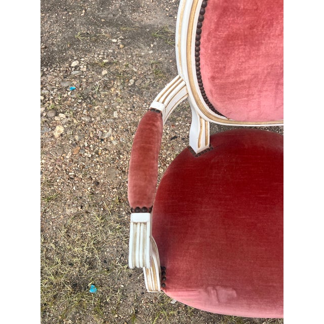 Pair of 19th Century Louis XVI Armchairs featuring hand-carved and painted wood frames with elegant fluted legs and...