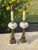 Pair of vintage milk glass and brass lamps on marble bases. The lamps feature a hand-painted floral design on the central...