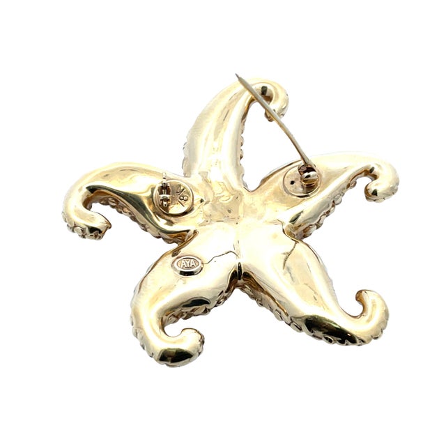 Bold 18k yellow gold starfish pin with rich textured detailing, crafted by AYA. Weighing 7 grams. This sculptural brooch...