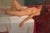 Reclining Nude by Kang Cho | Oil Painting of a nude woman lying on a bed For Sale