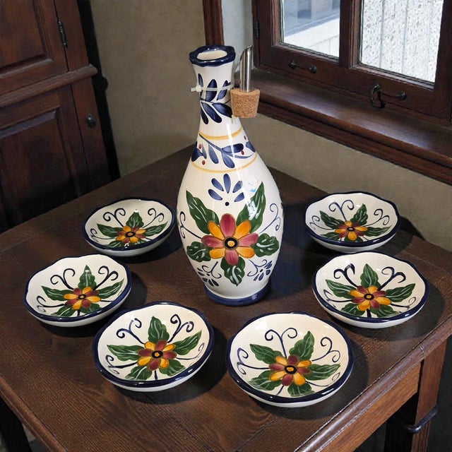 The Seven Piece Whole Home Painted Talavera Style Olive Oil Dipping Set is a beautifully crafted set featuring a floral...