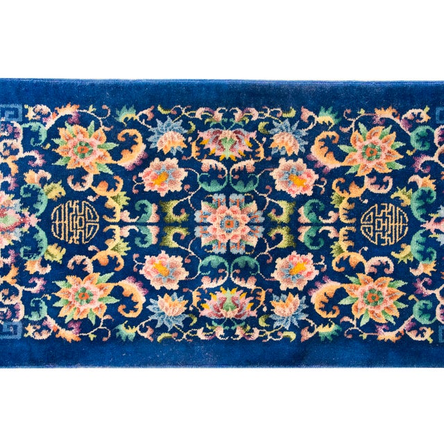 This exquisite hand-woven Chinese Art Deco rug from the 1930s features a vibrant royal blue field adorned with a dense,...