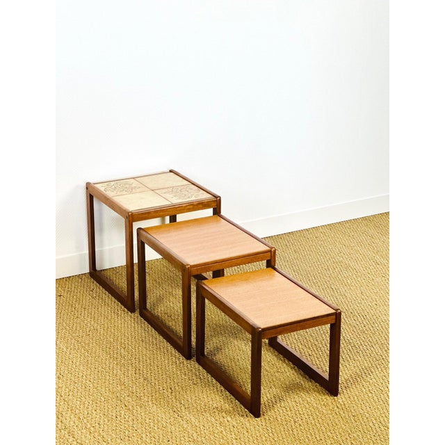 A lovely set of three nesting tables in a scandinavian design typical of the 1960s. the solid teak frame features clean,...